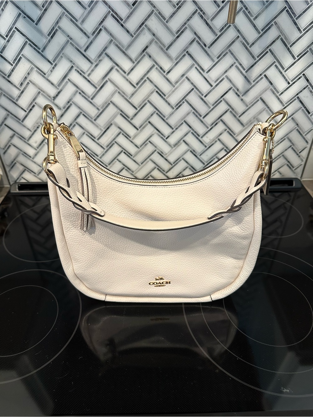 Coach Pebbled Leather Jules Hobo Bag in Chalk with gold hardware.